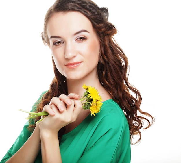 Beautiful young woman with big yellow dandelions