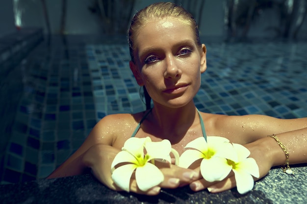 beautiful young woman with blue eyes in the pool