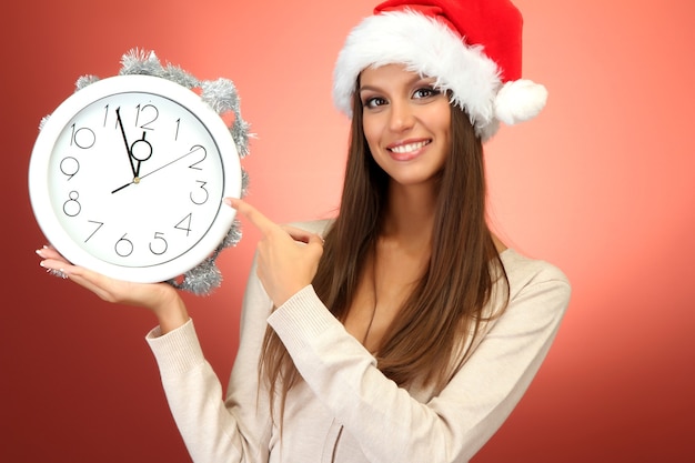 Beautiful young woman with clock