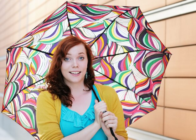 Beautiful young woman with colorful umbrella