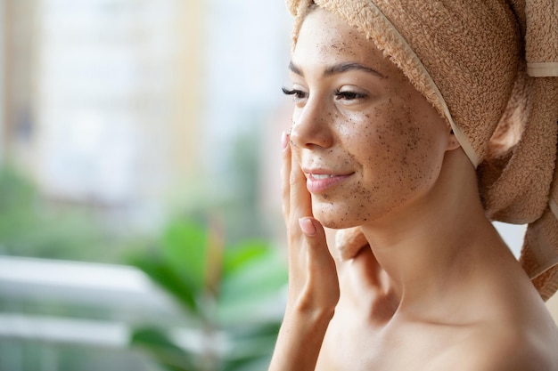 Beautiful young woman with cosmetic spa facial mask