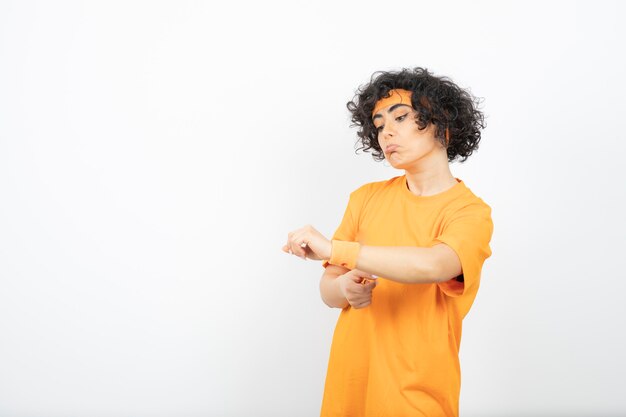 Beautiful young woman with curly hair wearing sporty fashion.