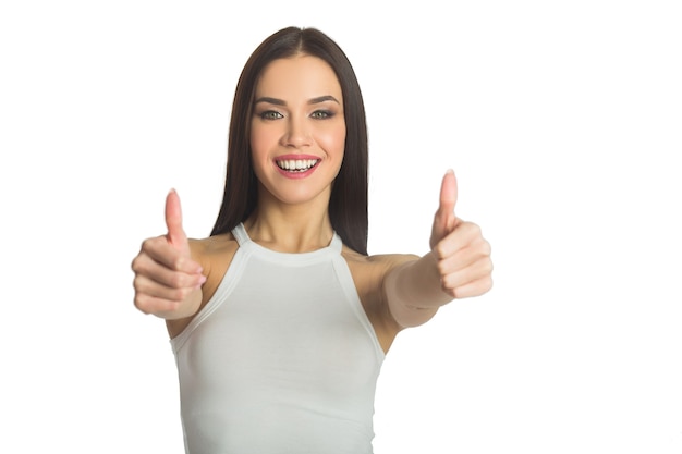 beautiful young woman with dark hair on white background with hand gesture