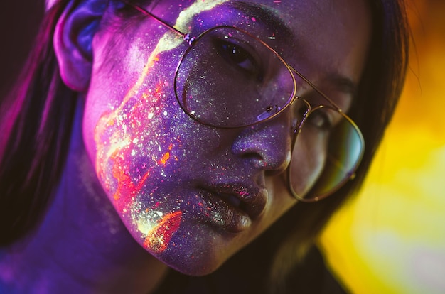 beautiful young woman with face paint wearing eyeglasses