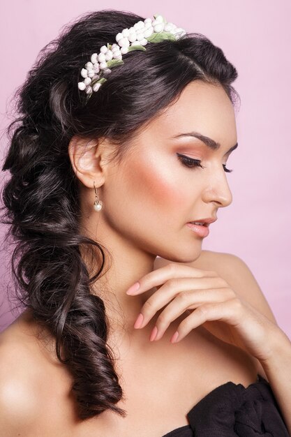 Beautiful young woman with a floral ornament 