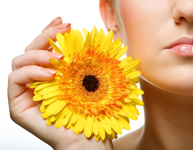 Beautiful young woman with gerber flower