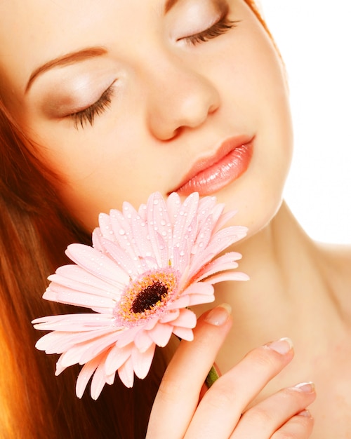 Beautiful young woman with gerber flower