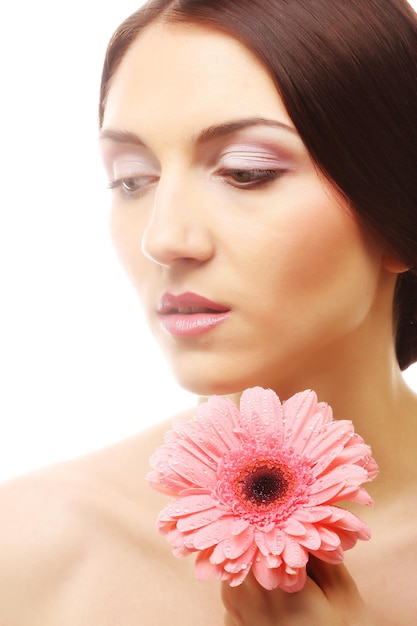 Beautiful young woman with gerber flower