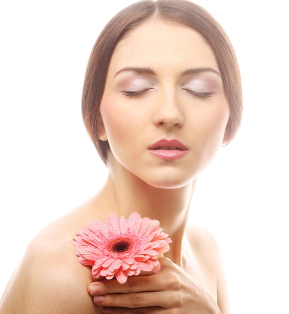 Beautiful young woman with gerber flower