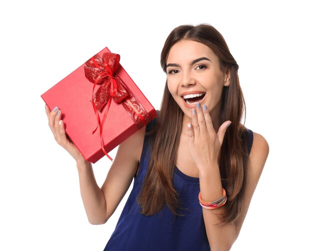 Beautiful young woman with gift for Valentine's Day on white background