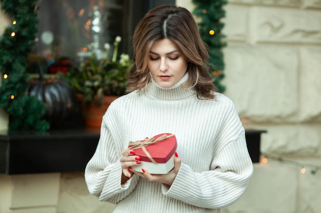 Beautiful young woman with gifts