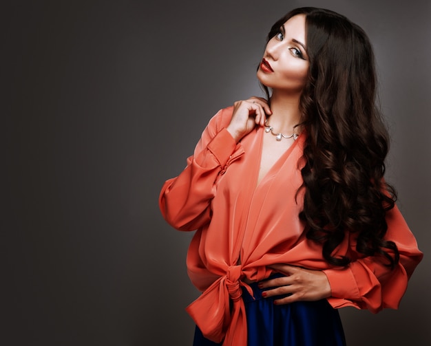 Beautiful young woman with long hair and jewelery.