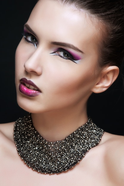 Beautiful young woman with long hair and jewelery.