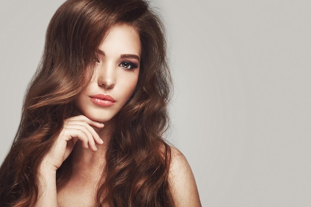 Beautiful young woman with long wavy hair