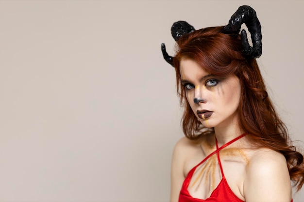 Beautiful young woman with makeup zodiac signs of Capricorn or Aries or Taurus Girl with horns on head