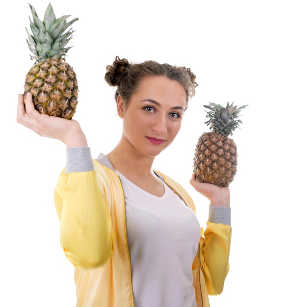 Beautiful young woman with pineapple isolated on white