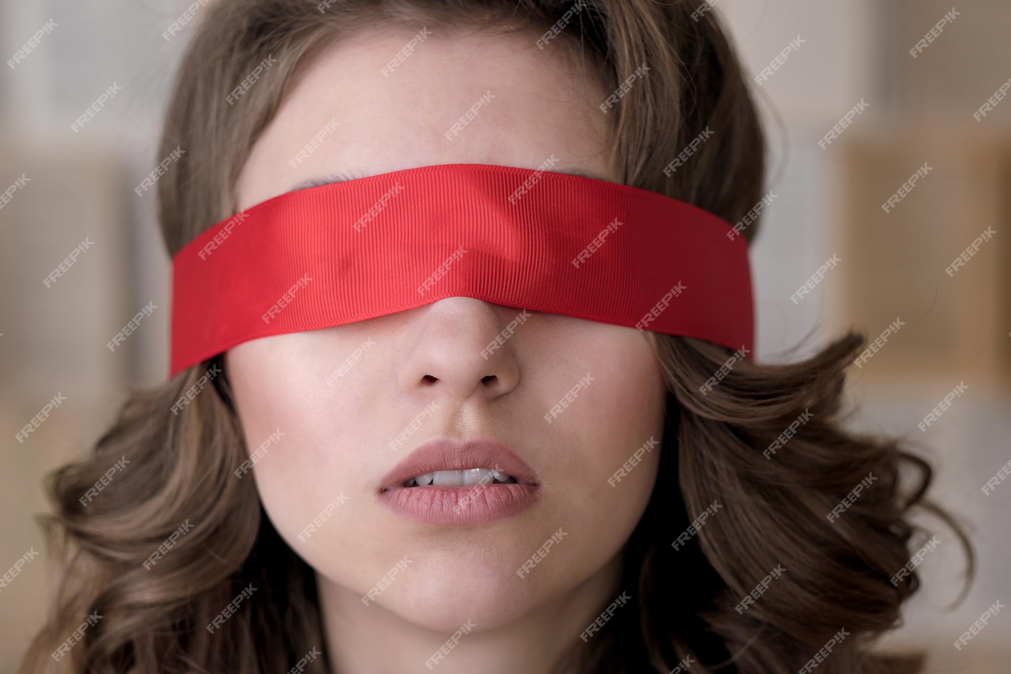 Premium Photo Beautiful young woman with a red blindfold