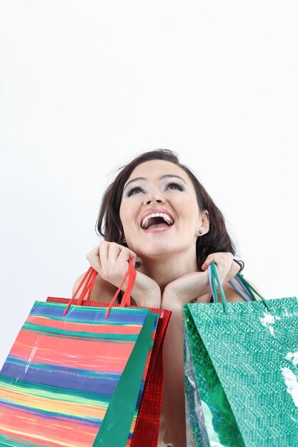 Beautiful young woman with shoppingisolated on white