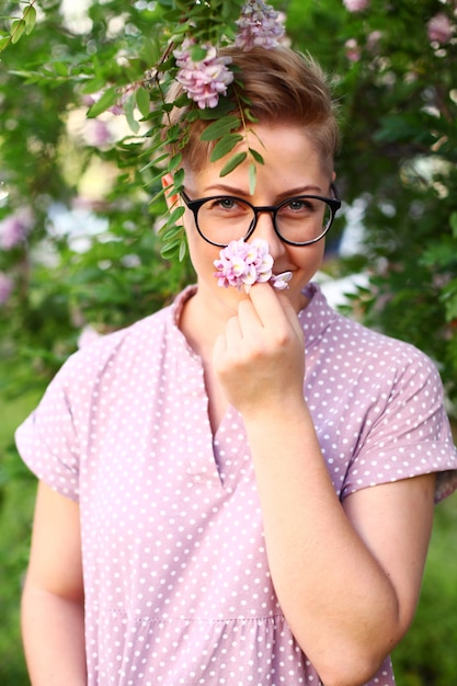 Beautiful young woman with short hair in the garden