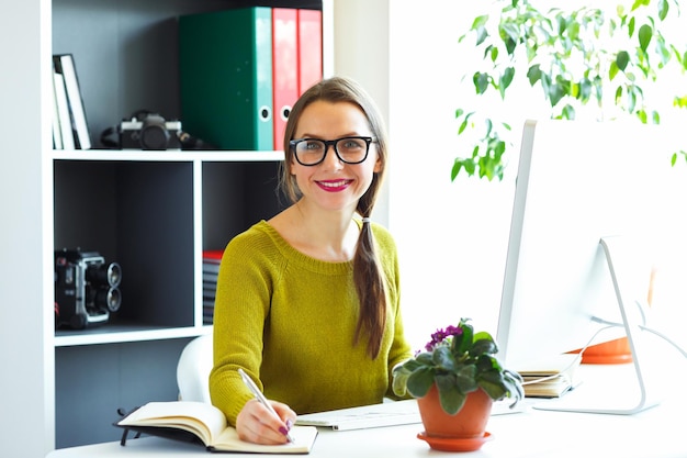 Beautiful young woman working from home modern business concept