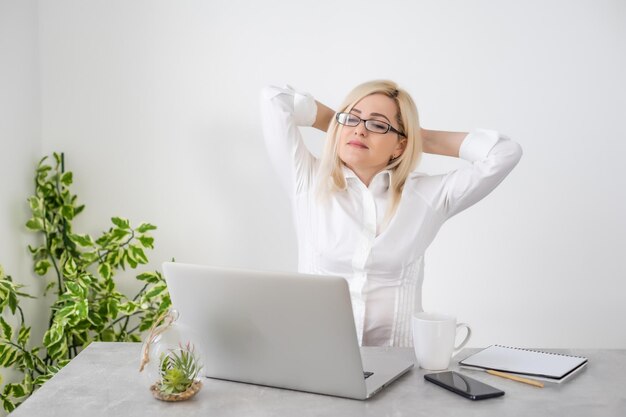 Beautiful young woman working on her laptop in her office.