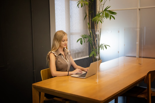 Beautiful young woman working using computer laptop concentrated and smiling