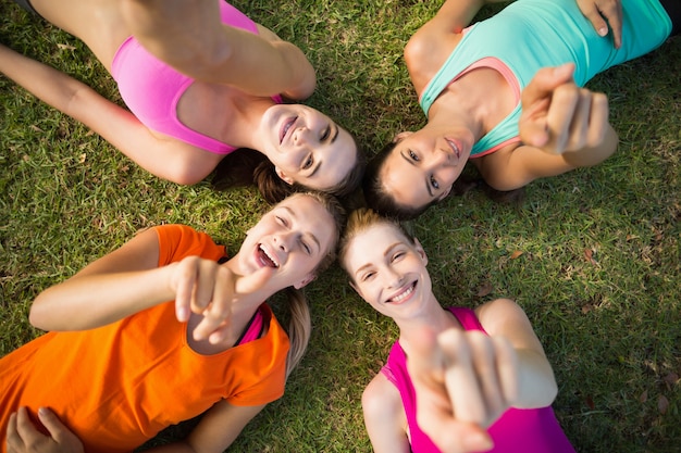 Beautiful young women lying and pointing