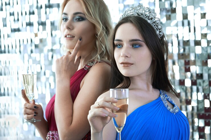 クリスマスや新年のお祝いに捧げられたお祝いパーティーでワインのグラスでポーズをとる美しい若い女性