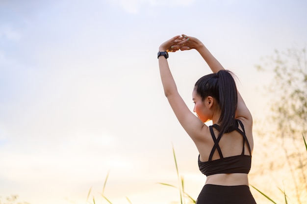 Beautiful young women prepare to exercise outdoors.