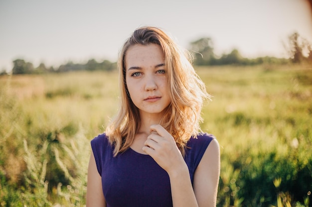 Beautiful young women in the warm autumn light with golden leaves on trees