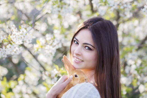 Beautiful young women with rabbit