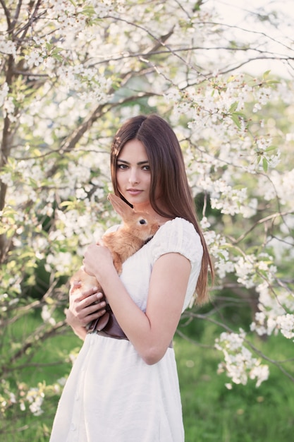 Beautiful young women with rabbit