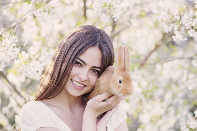 Beautiful young women with rabbit