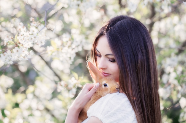 Beautiful young women with rabbit