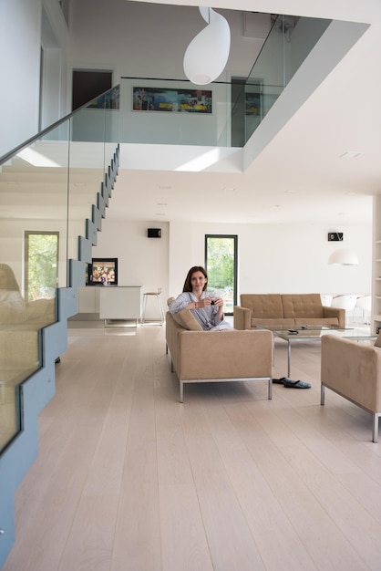 Beautifull young woman in a bathrobe enjoying morning coffee in her luxurious home villa