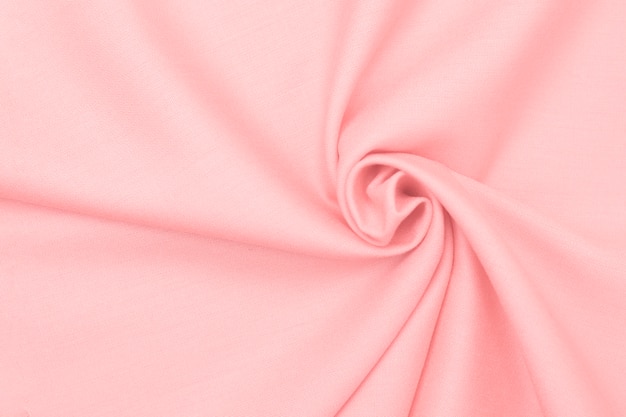 Beautifully crumpled delicate texture of pink fabric