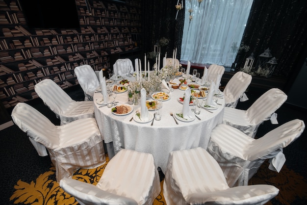 Beautifully decorated and arranged chairs for a festive Banquet. Decor, wedding.