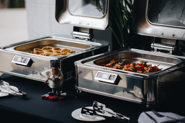 Beautifully decorated catering banquet table with different food snacks and appetizers on corporate christmas birthday party event or wedding celebration