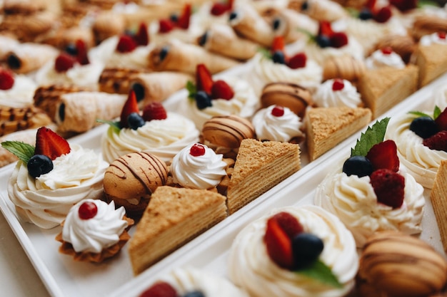 Beautifully decorated catering banquet table with different food snacks and appetizers