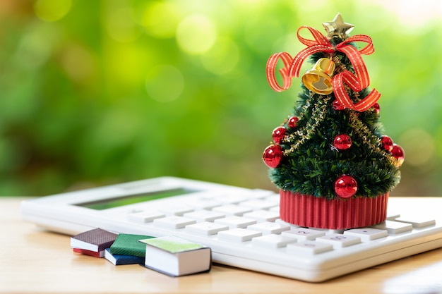 A beautifully decorated Christmas tree placed on a white calculator 