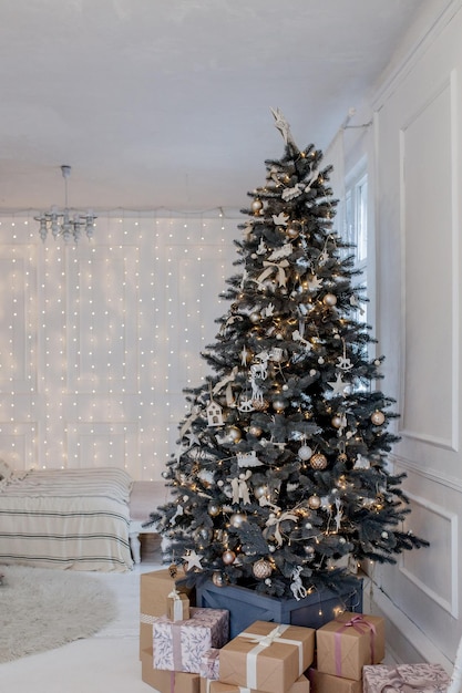 Beautifully decorated Christmas tree with many presents under it