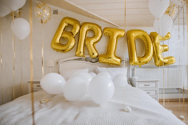 Beautifully decorated room for gathering the bride with balloons and the inscription bride