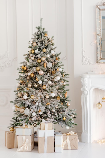 A beautifully decorated room with a Christmas tree with gifts underneath Interior Christmas magic luminous tree new year Soft selective focus