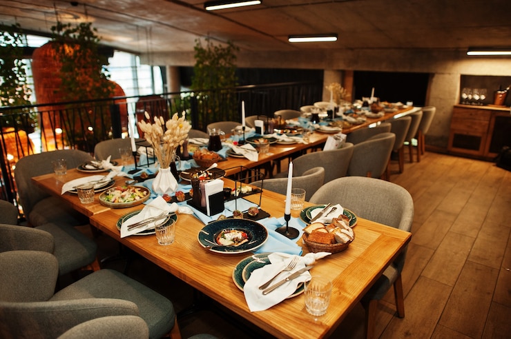 Photo beautifully laid tables with food, glasses and appliances in restaurant.