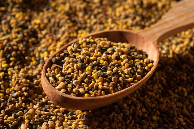 A beautifully shot spoon with bee pollen in granules