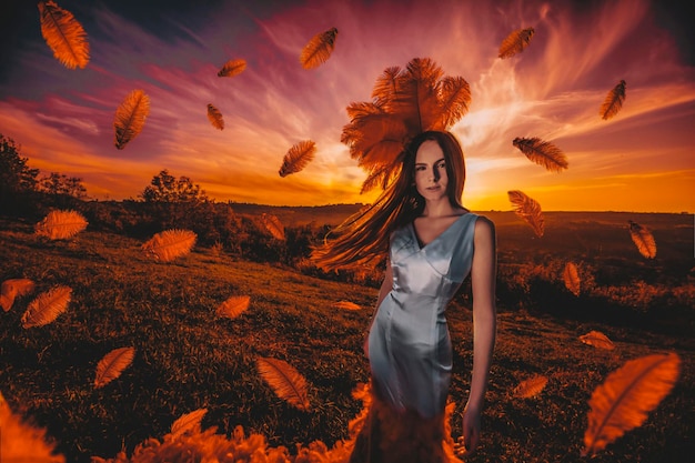 Beautiul woman in sunset with feathers