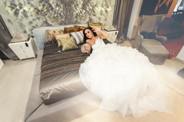 Beauty adult bride in white wedding dress indoor Top view