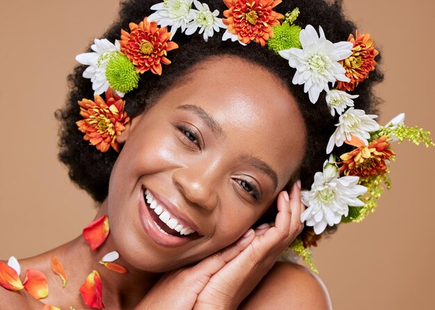 Beauty art and black woman with flower crown in hair and smile on face portrait with studio background Nature happy woman with flowers natural skincare or hair care with sustainable ingredients