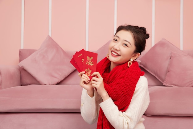 Beauty asian woman celebrates chinese new year red packet