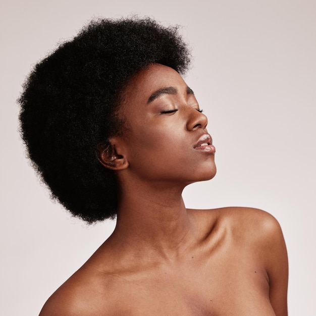 Beauty black woman and skincare spa aesthetic with skin glow and cosmetics in a studio Dermatology facial and self care of a young person model feeling calm from cosmetic and detox treatment